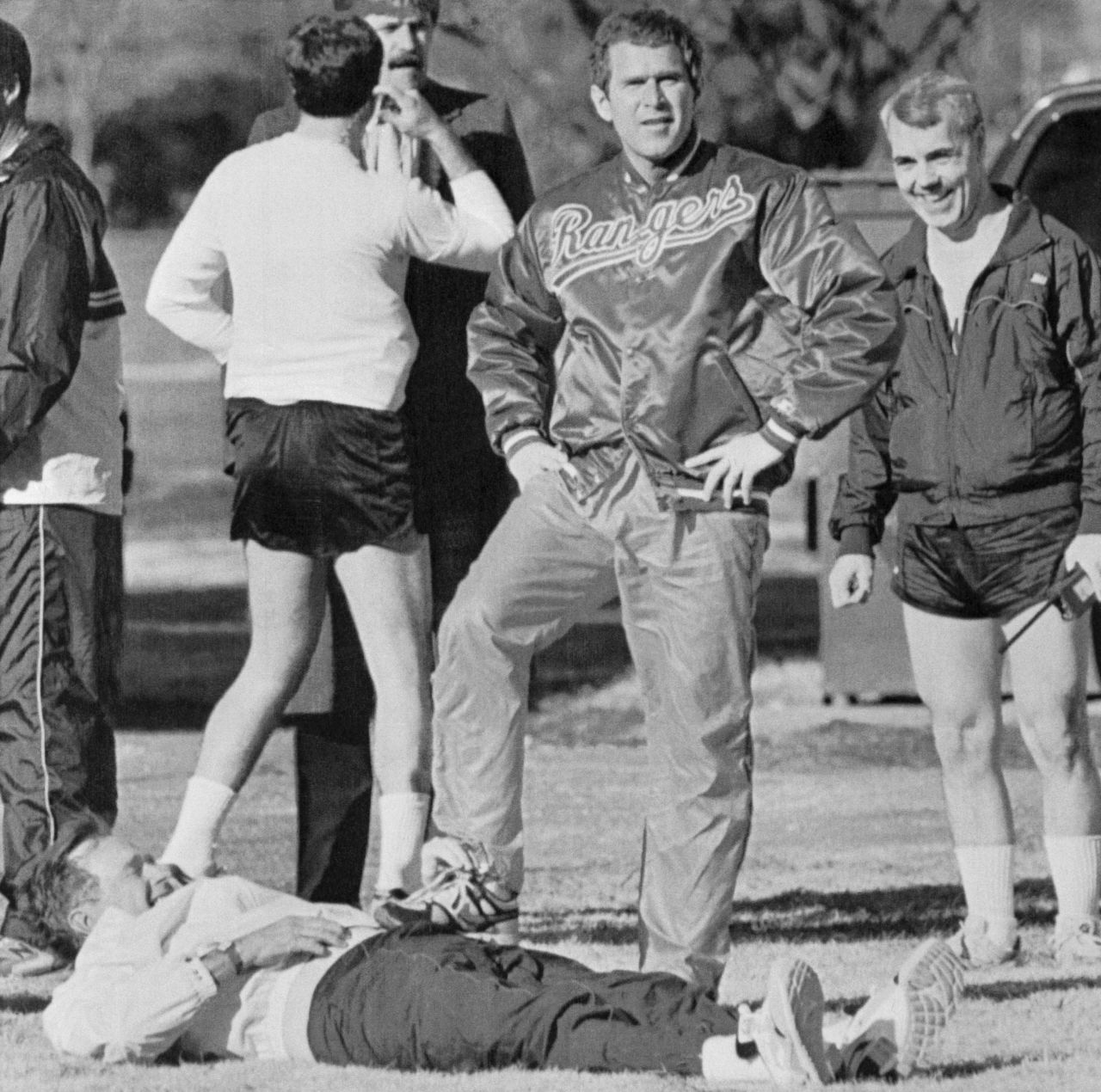 Bush has a "leg up" on his father as he clowns around for the camera in 1990. A year earlier, the younger Bush became part-owner of the Texas Rangers baseball team.