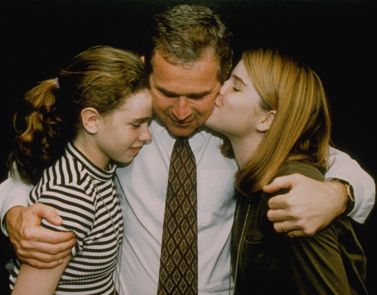 Bush hugs his daughters Barbara, left, and Jenna after his election win in 1994.