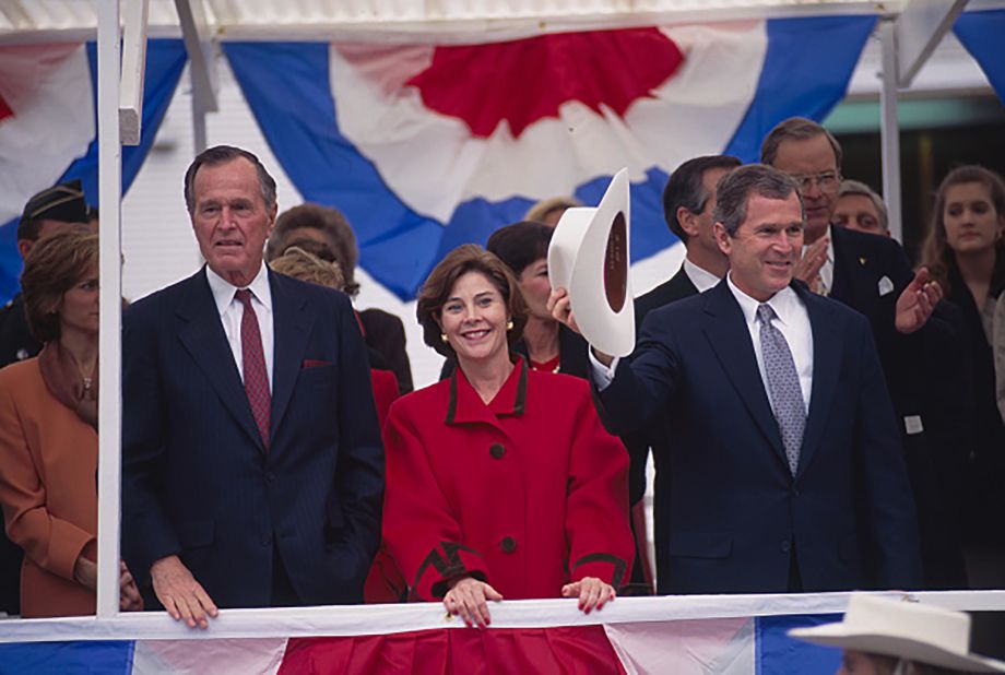 Bush's father joins him and Laura at his inauguration in Texas in 1994. Bush went on to win a second term in 1998 before running for president.