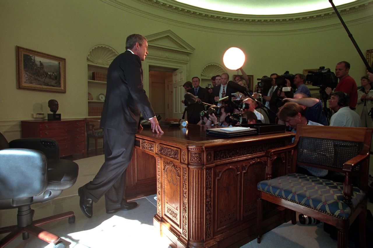 Bush addresses the media in the White House Oval Office after a telephone call with New York Gov. George Pataki and New York City Mayor Rudy Giuliani on September 13, 2001.