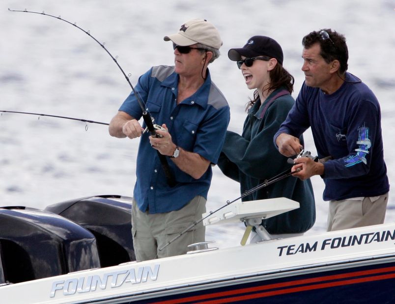Bush reels in a catch in Kennebunkport, Maine, in 2007. Watching is his daughter, Barbara, and cousin Billy.