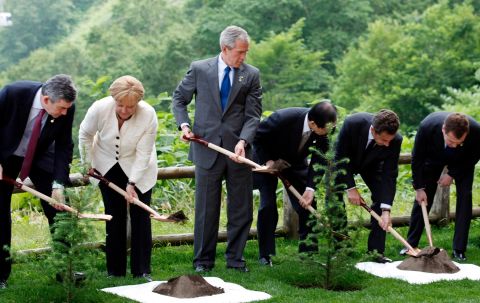 Bush and other world leaders plant a memorial tree after a working session at the G8 summit in Toyako, Japan, in June 2008.