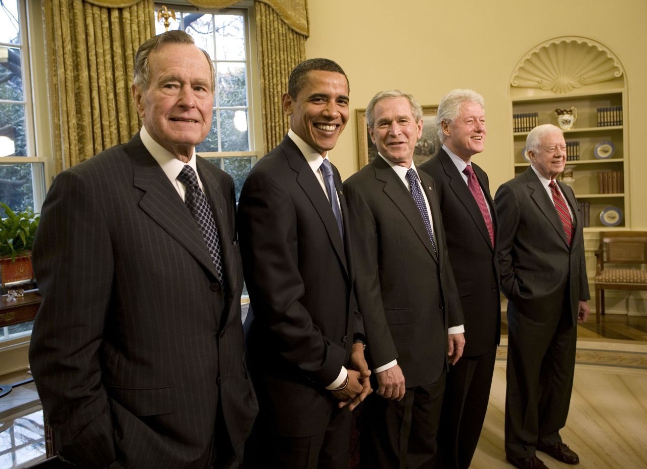 Bush poses with President-elect Barack Obama and three former presidents in the White House Oval Office in January 2009.