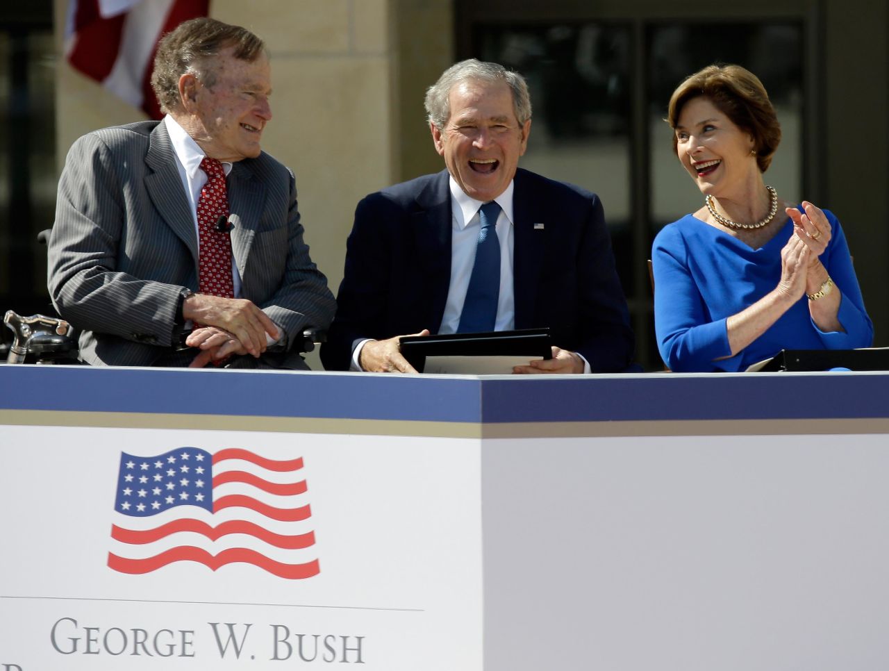 Bush, his wife and his father attend the dedication of his presidential library near Dallas in 2013.