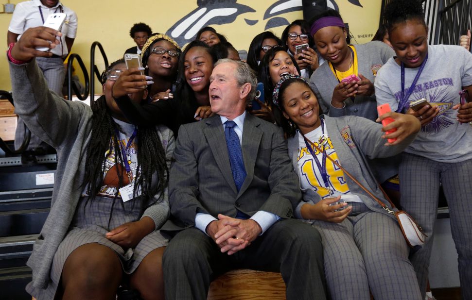Bush poses with students at a New Orleans high school in 2015. He was in town for the 10th anniversary of Hurricane Katrina.