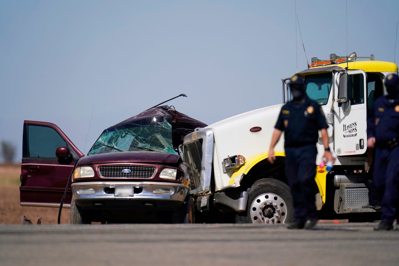Law enforcement officers work at the scene of a <a href="https://www.cnn.com/2021/03/02/us/imperial-california-crash/index.html" target="_blank">deadly crash</a> in Holtville, California, on Tuesday, March 2. At least a dozen people were killed after an SUV packed with people pulled out in front of a semitruck towing two trailers, officials said. (CNN has blurred the license plate in this image.)