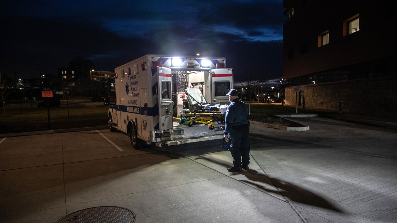 A paramedic loads a cleaned stretcher onto the back of an ambulance before heading out for another call. The pandemic has only exacerbated decades-long trends in American death rates described in a new report.