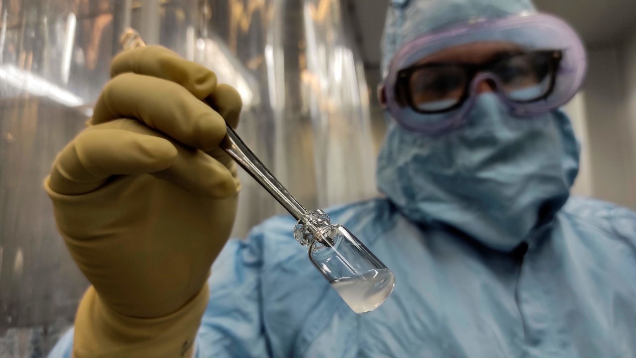 Technician Yoel Hernandez shows a vaccine at the Vaccine Aseptic and Packaging Processing Plant of the Finlay Vaccine Institute in Havana, on January 20, 2021. 