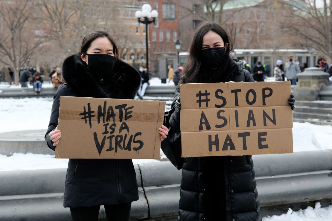 Demonstrators hold signs at rally to protest violence against Asian Americans on February 20 in New York City.