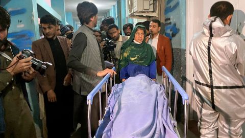 Afghans carry the body of a woman who was killed in Jalalabad, Afghanistan, on March 2.