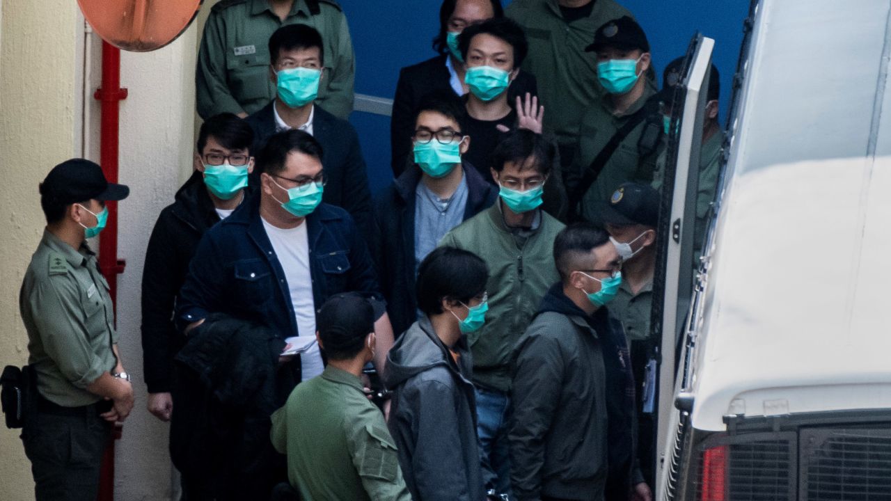 Hong Kong pro-democracy activists are escorted into a van as they leave the Lai Chi Kok Reception Centre, the day after appearing at the West Kowloon Court on the charge of conspiracy to commit subversion, in Hong Kong on March 2, 2021.