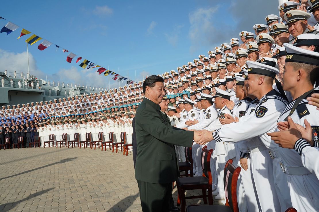 Chinese President Xi Jinping, meets with representatives of the aircraft carrier unit and the manufacturer at a naval port in Sanya, south China's Hainan province on Dec. 17, 2019.