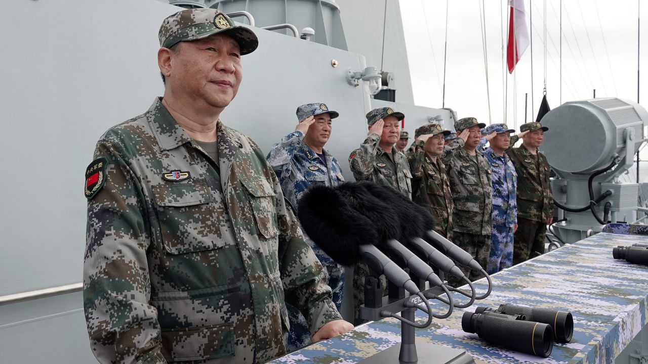 In this April 12, 2018, file photo released by Xinhua News Agency, Chinese President Xi Jinping, left, speaks after he reviewed the Chinese People's Liberation Army (PLA) Navy fleet in the South China Sea. From Asia to Africa, London to Berlin, Chinese envoys have set off diplomatic firestorms with a combative defense whenever their country is accused of not acting quickly enough to stem the spread of the coronavirus pandemic.