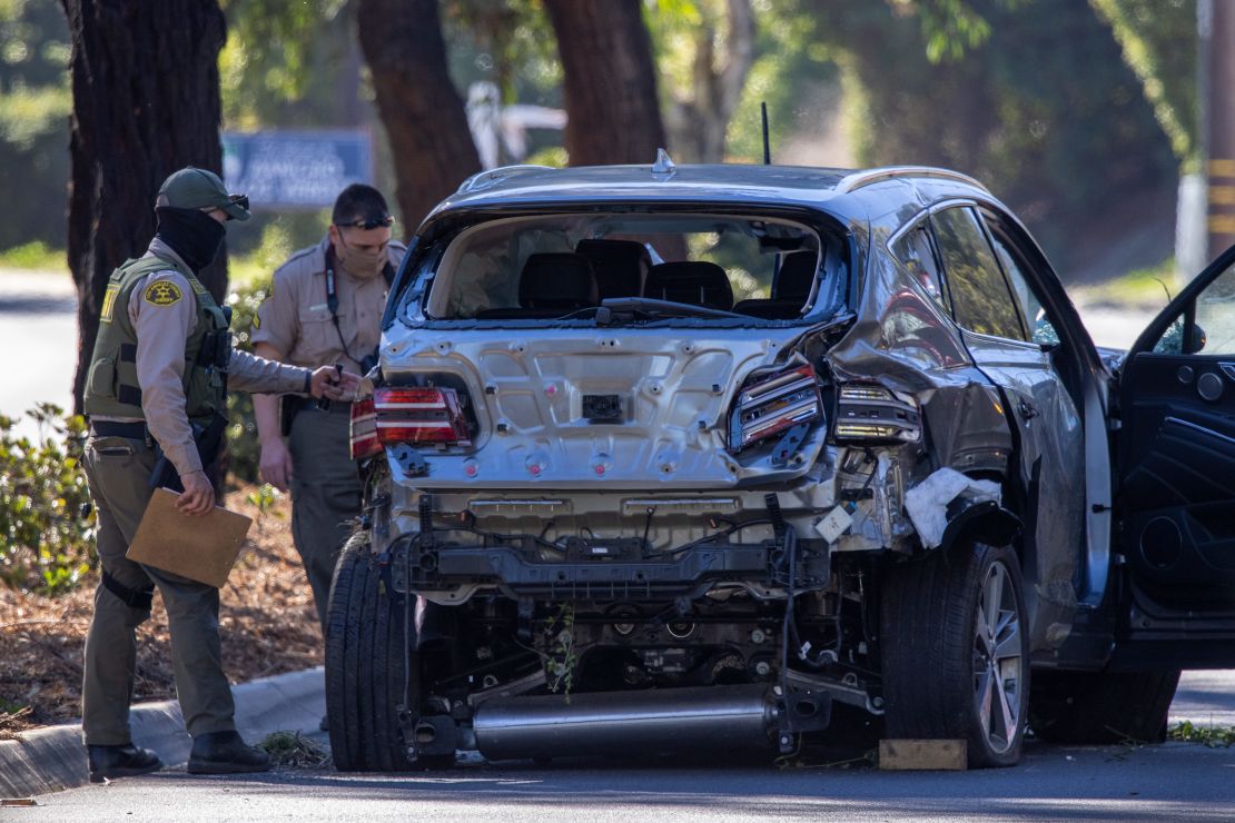 Los Angeles County Sheriff deputies gather evidence from the car Tiger Woods was driving when he seriously injured on February 23, 2021 in Rolling Hills Estates, California

