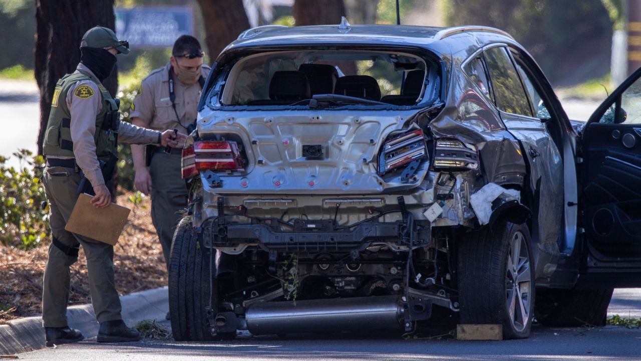 Los Angeles County Sheriff deputies gather evidence from the car Tiger Woods was driving when he seriously injured on February 23, 2021 in Rolling Hills Estates, California