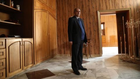 Deacon Louis Climis stands in Our Lady of Salvation Church's sacristy where dozens took cover, and perished, as terrorists laid siege to the church in 2010. The deacon and his son, along with dozens of other worshipers, took cover in this room during the massacre. 