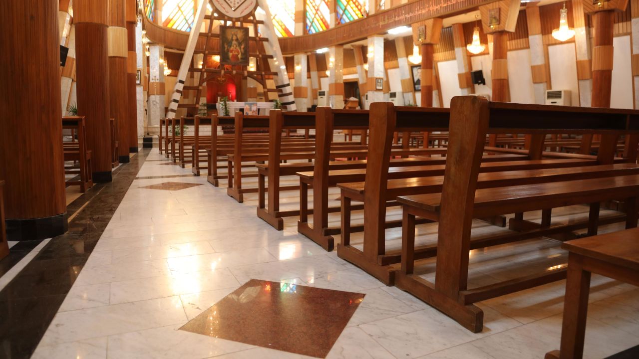 The dark red squares on the floor scattered throughout the Our Lady of Salvation church mark the places where people died as terrorists laid siege to the church. Pope Francis is set to meet with a small gathering at this church on Friday, the first day of his historic visit. 