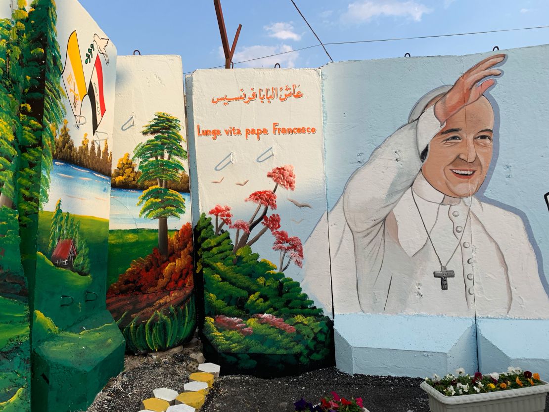 Blast walls which continue to surround the Our Lady of Salvation church are adorned with murals of Pope Francis in preparation for the historic papal visit.