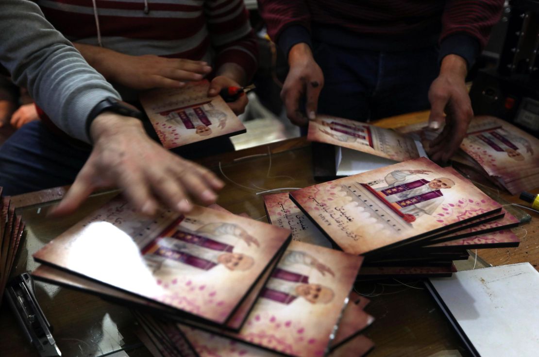Workers print flyers of Pope Francis at a shop in Erbil, the capital of Iraq's northern autonomous Kurdish region.