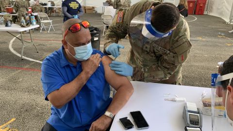 Guillermo Muñoz, a school principal in Miami-Dade County, receives a Johnson & Johnson vaccine shot Wednesday at a FEMA-run site at Miami Dade College.