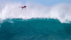TOPSHOT - Hawaii's Billy Kemper falls off his board during the Da Hui Backdoor shootout at the Pipeline on Oahu's North Shore on January 13, 2019. (Photo by brian bielmann / AFP) / RESTRICTED TO EDITORIAL USE        (Photo credit should read BRIAN BIELMANN/AFP via Getty Images)