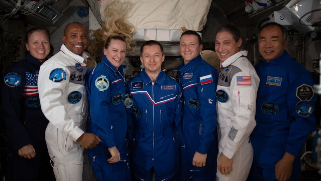 The seven-member Expedition 64 crew poses for a portrait inside the International Space Station. From left are, NASA astronauts Shannon Walker, Victor Glover and Kate Rubins; Roscosmos cosmonauts Sergey Ryzhikov and Sergey Kud-Sverchkov; NASA astronaut Michael Hopkins; and JAXA astronaut Soichi Noguchi. 