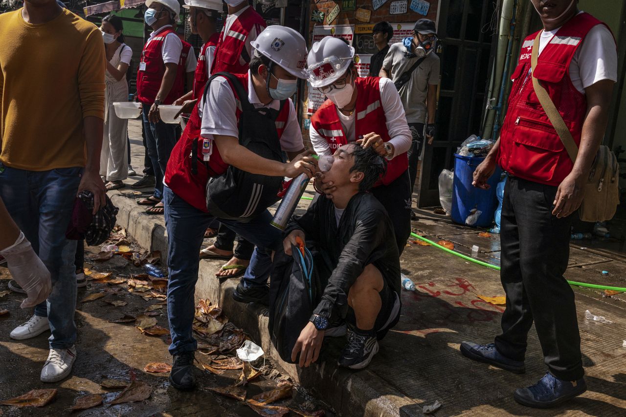 Medics help supply oxygen to a protester who was exposed to tear gas in Yangon on March 3.