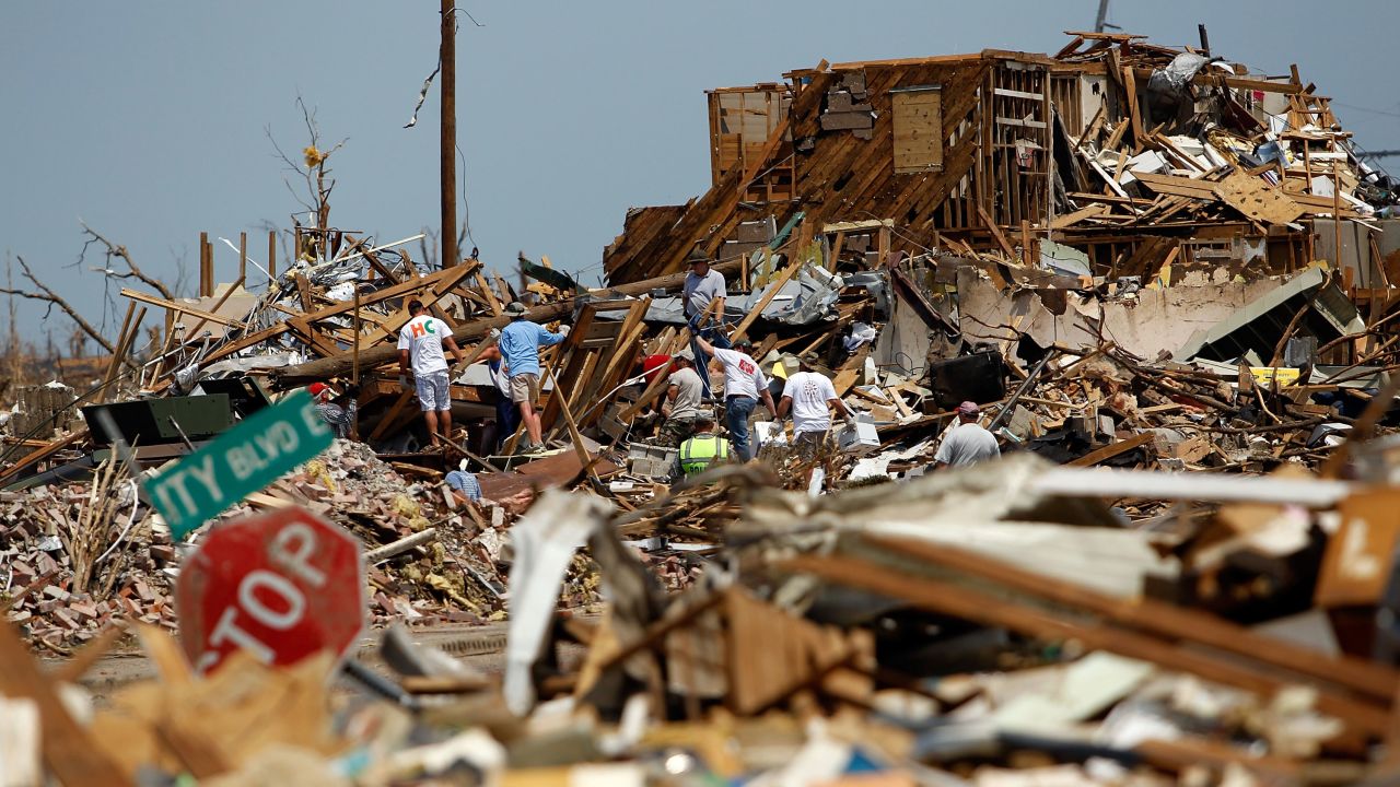 Volunteers search through destroyed homes on April 30, 2011, in Tuscaloosa, Alabama.