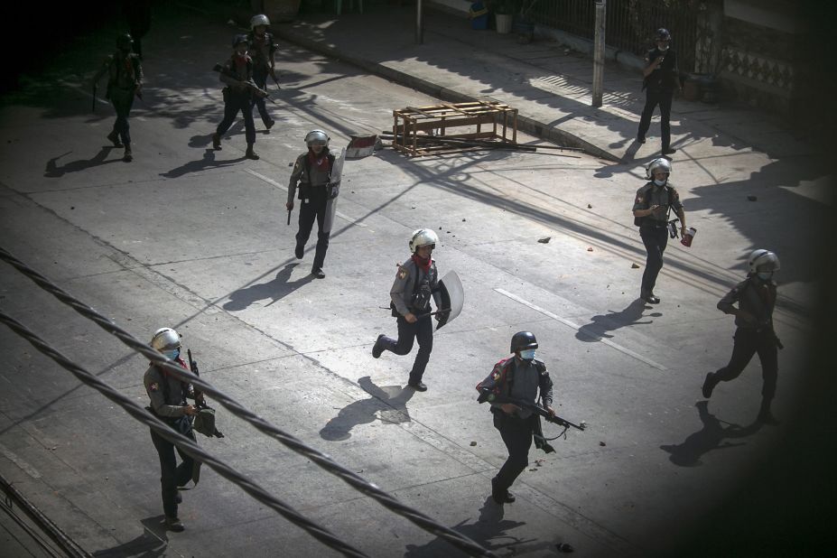 Police run toward protesters to disperse a demonstration in Yangon on March 3.