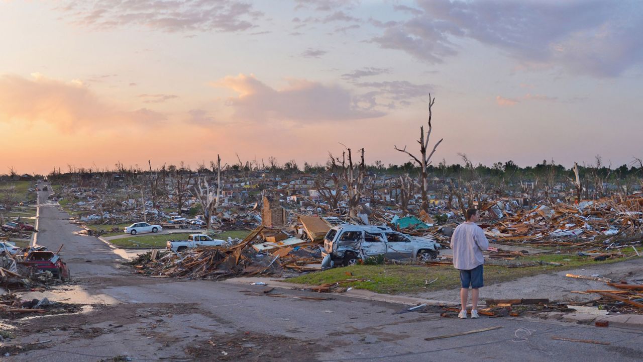 A person surveys damage one day after a tornado tore through Joplin, Missouri, killing dozens on May 23, 2011.
