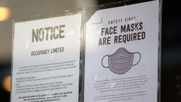 Covid-19 restriction signs hang outside of Chipotle on March 3, 2021 in Austin, Texas. Gov. Greg Abbott announced today that the state will end its mask mandate and allow businesses to reopen at 100 percent capacity on March 10. 