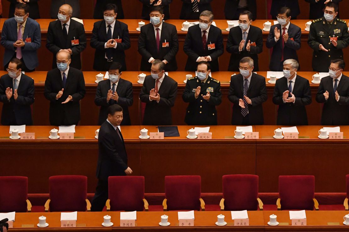 Delegates applaud as Chinese President Xi Jinping arrives for the opening ceremony of the Chinese People's Political Consultative Conference (CPPCC) at the Great Hall of the People in Beijing on March 4.