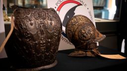 This picture taken on March 3, 2021, shows a breastplate and a ceremonial helmet during their official restitutions by the French Central Directorate of the Judicial Police (DCPJ) to the Louvre Museum, in Paris. - A breastplate and a ceremonial helmet, two "exceptional" objects from the Italian Renaissance, were handed over by the police to the Louvre museum after being found in Bordeaux during an auction linked to an estate. These objects, which belonged to the collection of the Baroness de Rothschild, had been donated to the Louvre in 1922 and stolen in 1983. Estimations say they worth around 500,000 euros. (Photo by Thomas SAMSON / AFP) (Photo by THOMAS SAMSON/AFP via Getty Images)