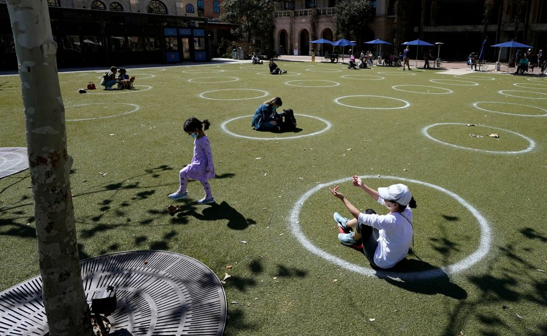 Visitors to the Pearl Brewery use circles marked for social distancing to help battle the Covid-19 virus, Wednesday, March 3, 2021, in San Antonio.