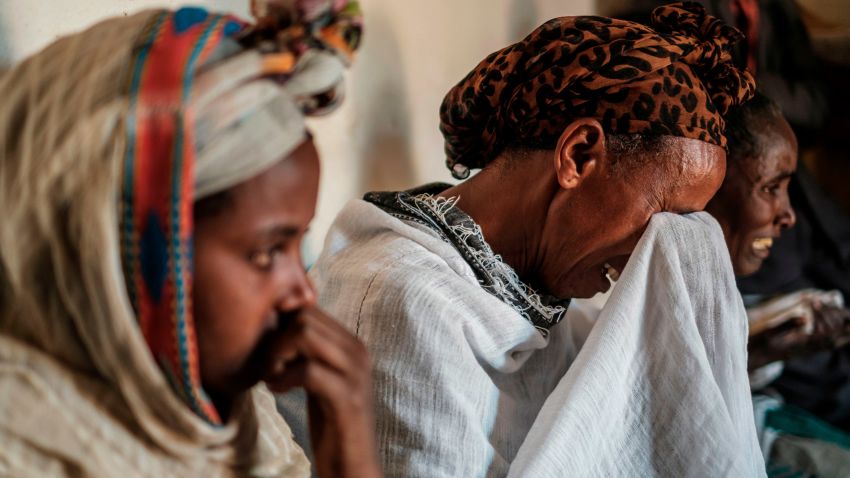 People mourn the victims of a massacre allegedly perpetrated by Eritrean Soldiers, at the house of Beyenesh Tekleyohannes, in the village of Dengolat, North of Mekele, the capital of Tigray on February 26, 2021. - A report by Amnesty International on February 27, 2021 alleges Eritrean soldiers fighting in Tigray had killed hundreds of people in November last year in what the rights group described as a likely crime against humanity. The presence of Eritrean troops in Ethiopia in the Tigray conflict has been widely documented but has been denied by both countries. Tigray has been the theater of fighting since early November 2020, when Ethiopian Prime Minister Abiy Ahmed announced military operations against the northern region's former ruling party, the Tigray People's Liberation Front, accusing it of attacking federal army camps. (Photo by EDUARDO SOTERAS / AFP) (Photo by EDUARDO SOTERAS/AFP via Getty Images)