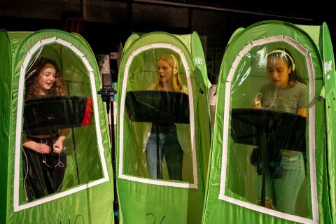 From left, high school students Emma Banker, Jessi McIrvin and Valerie Sanchez record their vocals in pop-up tents during a choir class in Wenatchee, Washington, on February 26. Wenatchee High School has been using the tents for its music programs during the Covid-19 pandemic.