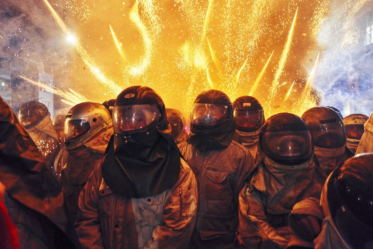 Fireworks explode behind people in Tainan, Taiwan, on Friday, February 26. The spacesuit-styled costumes are <a href="https://www.cnn.com/travel/article/taiwan-yanshui-beehive-fireworks-festival/index.html" target="_blank">an annual tradition</a> during the Yanshui Beehive Fireworks Festival.