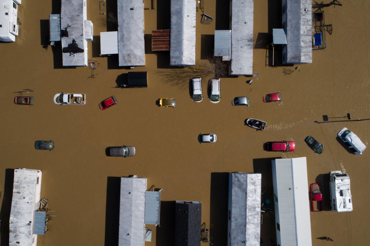 A boat weaves through partially submerged cars and trailers in Beattyville, Kentucky, on Tuesday. March 2. <a href="https://www.cnn.com/2021/03/02/us/kentucky-flood-vaccine-boat-rescue/index.html" target="_blank">Heavy rains</a> caused the Kentucky River to flood.