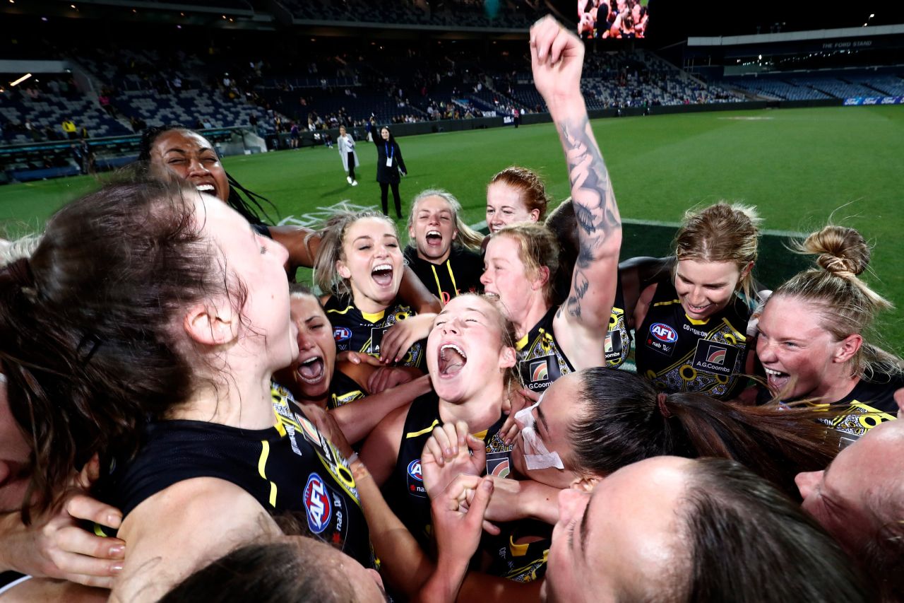 The Richmond Tigers celebrate after winning an Australian Football League match in Geelong, Australia, on Friday, February 26. It was the first-ever AFLW victory for the club, which joined the league last year.