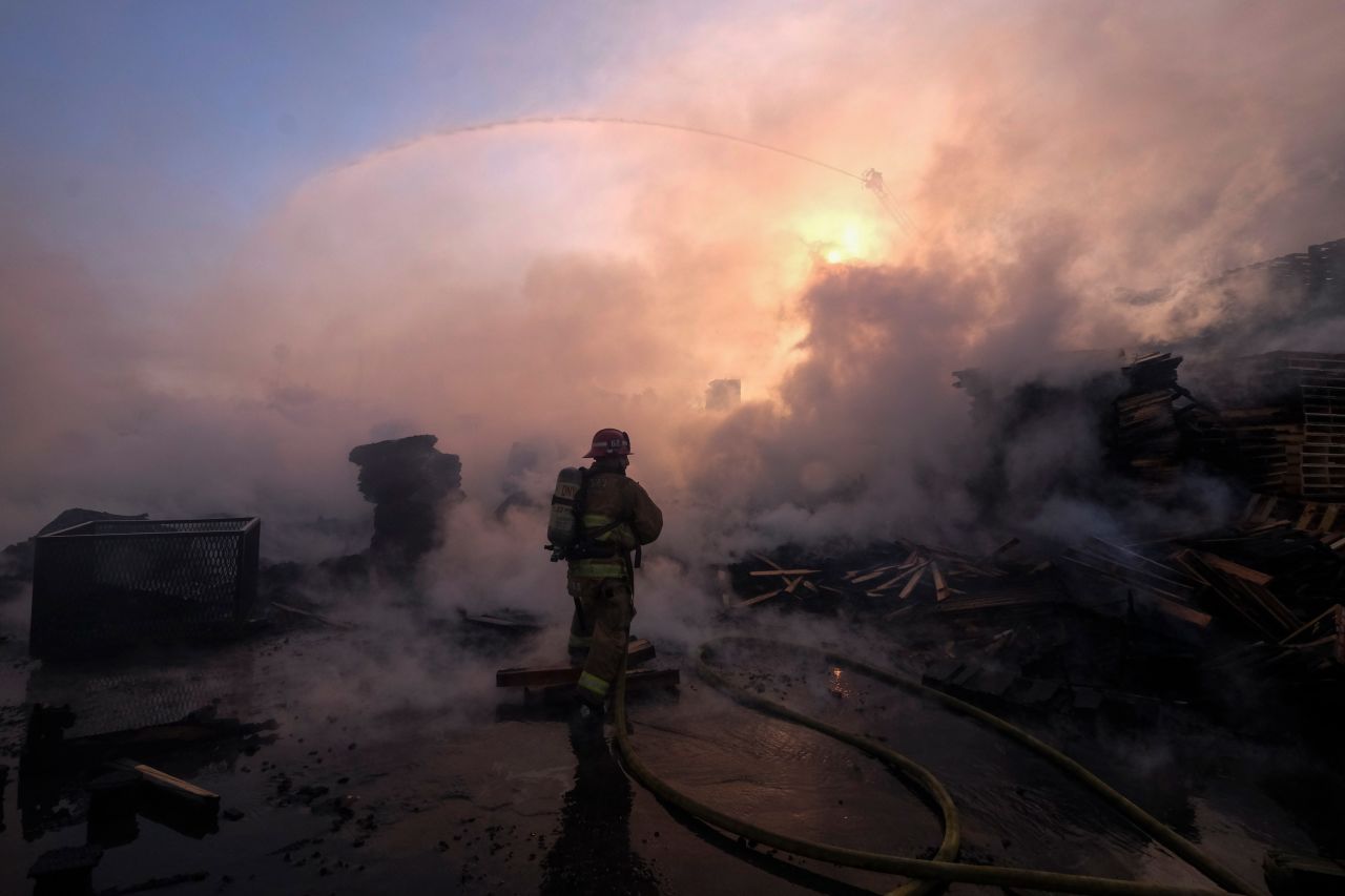 A firefighter battles flames at a commercial yard in Compton, California, on Friday, February 26. The fire consumed what appeared to be large stacks of pallets. <a href="http://www.cnn.com/2021/02/25/world/gallery/photos-this-week-february-18-february-25/index.html" target="_blank">See last week in 43 photos</a>