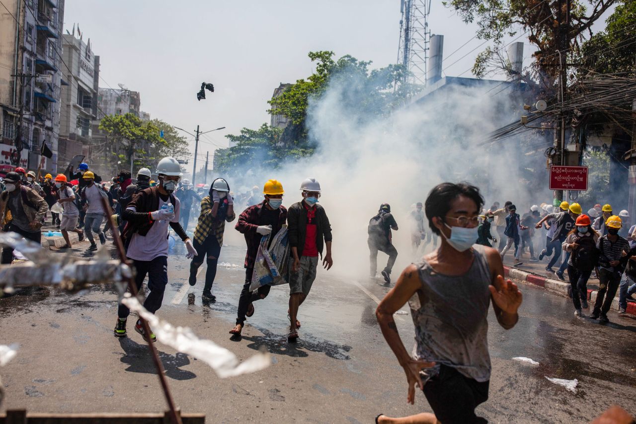 Anti-coup protesters run away from tear gas in Yangon, Myanmar, on Monday, March 1. <a href="http://www.cnn.com/2021/02/16/asia/gallery/myanmar-unrest/index.html" target="_blank">Protests have been taking part across the country</a> since the military seized power on February 1. Some have been met with deadly force.