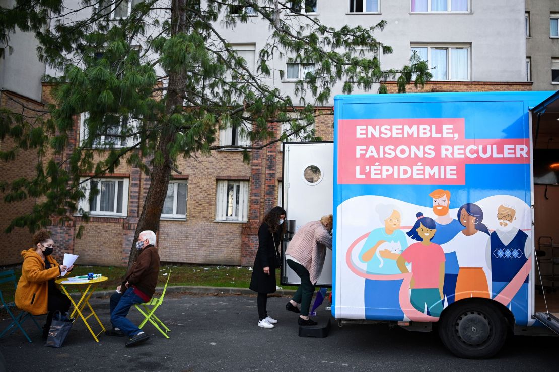 A woman enters a truck to receive a dose of Covid-19 vaccine outside her residential building in the Paris suburb of Stains on March 2.