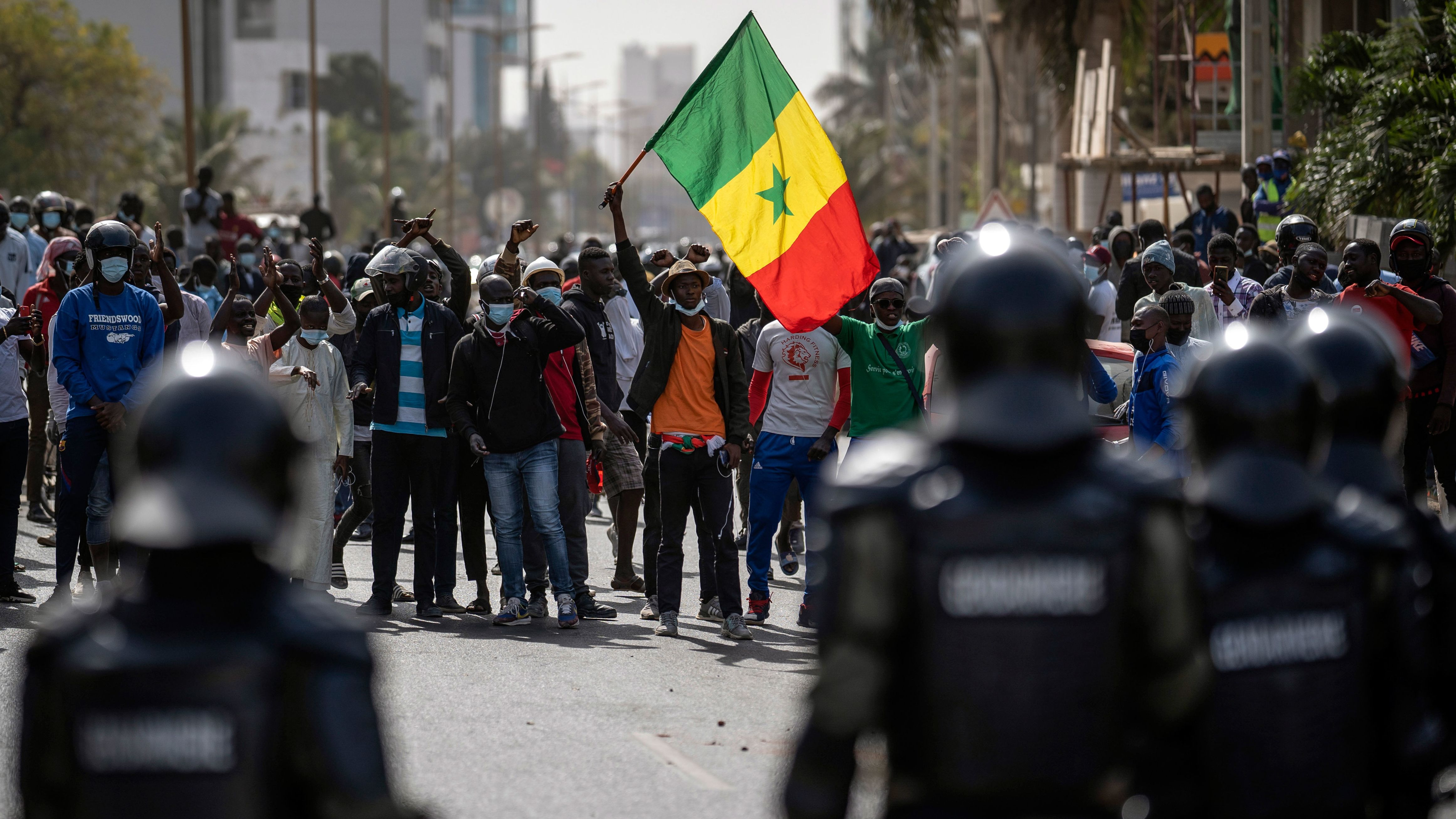 A demonstrator waves a Senegalese national flag during protests in support of main opposition leader and former presidential candidate Ousmane Sonko, who is accused of rape. 
