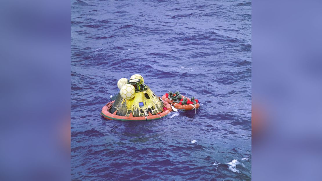 The Apollo 11 crew await pickup by a helicopter from the USS Hornet after returning to Earth.