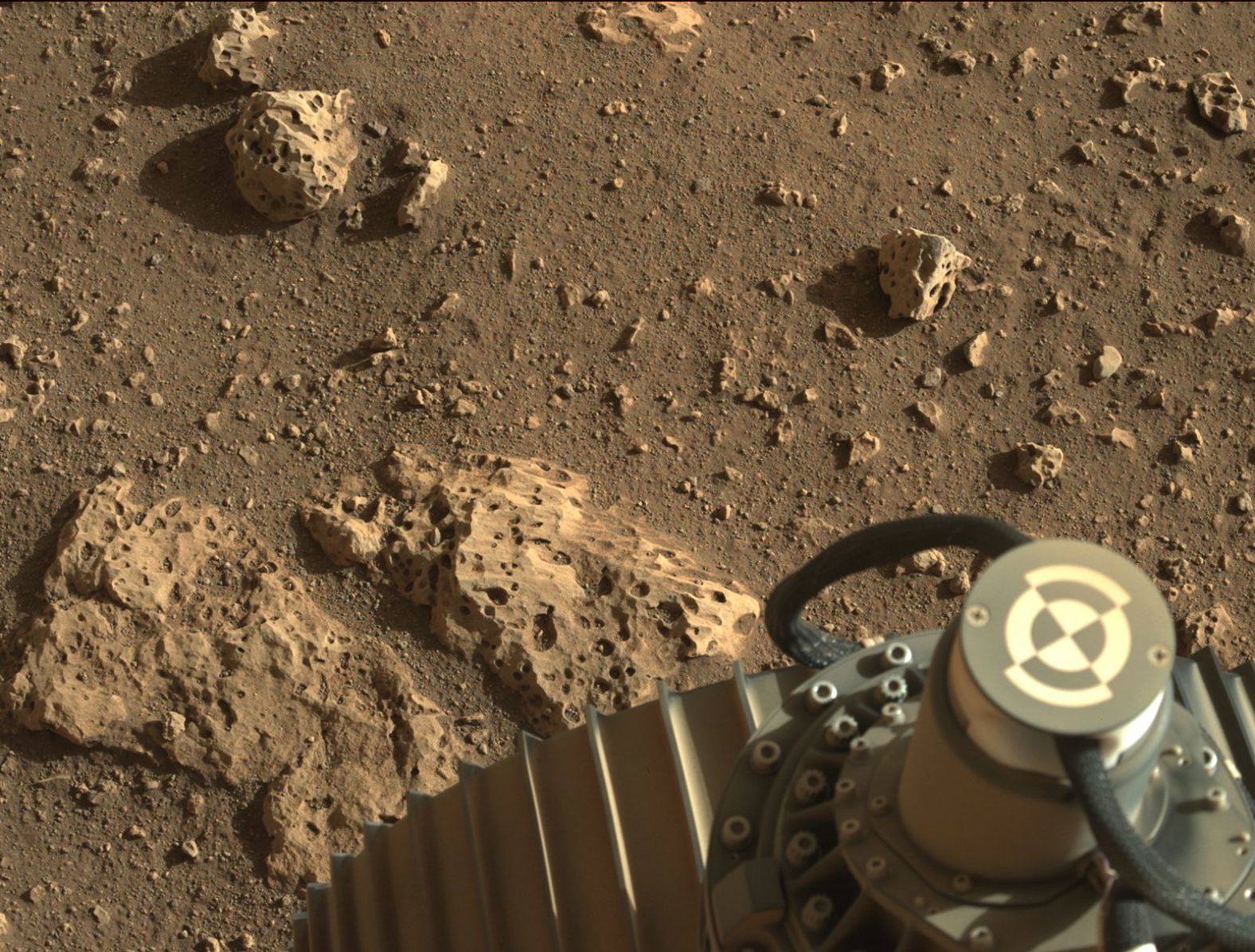 This image shows the rover's wheel on the surface of the red planet.