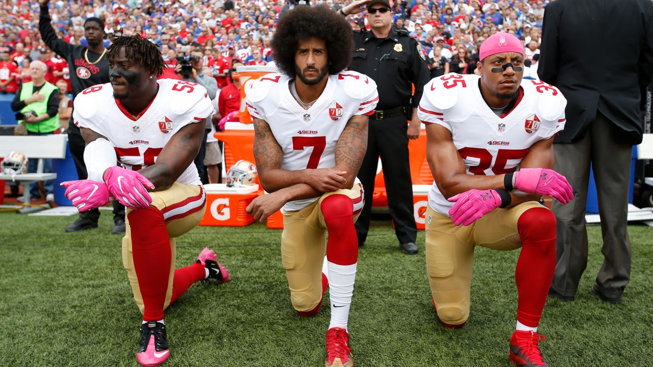 Eli Harold, Colin Kaepernick  and Eric Reid  of the San Francisco 49ers kneel during the anthem  a game in 2016 in Orchard Park, New York.  