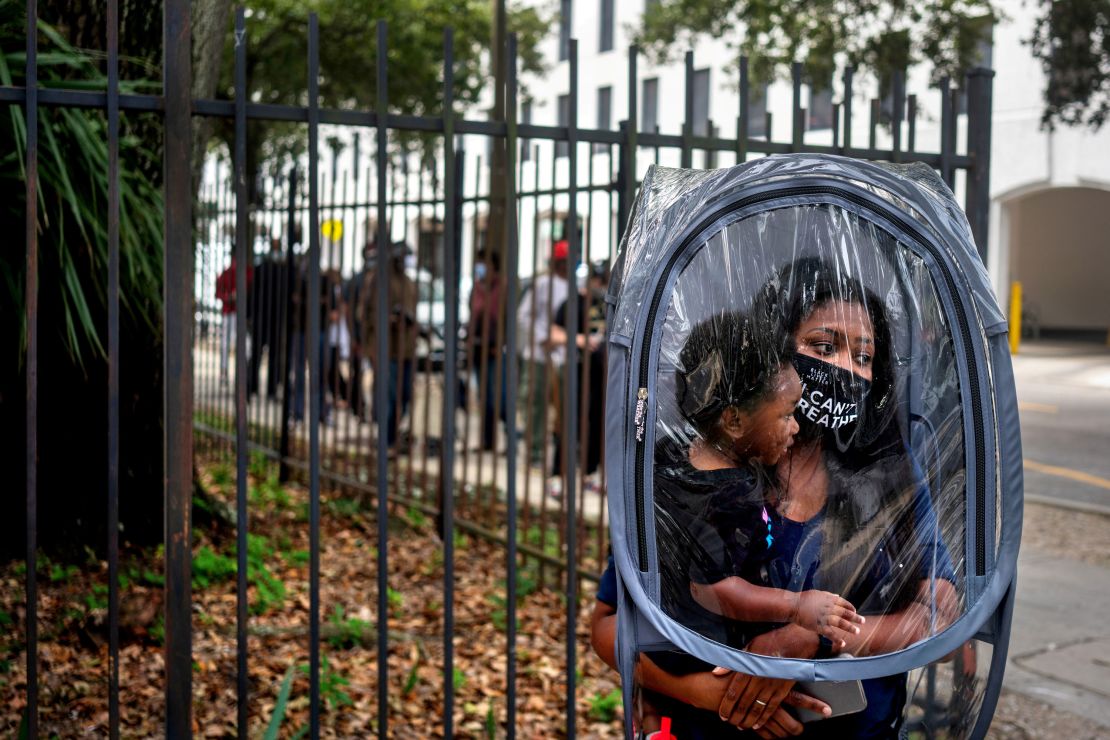 Dana Clark and her 18-month-old son Mason wait in line for early voting at New Orleans City Hall in October.