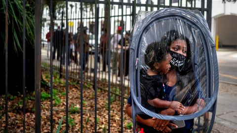 Dana Clark and her 18-month-old son Mason wait in line for early voting at New Orleans City Hall in October.