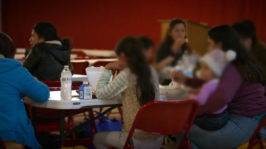 Newly arrived migrants get something to eat at the overflow shelter set up at Our Lady of Guadalupe in Mission, Texas