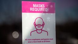 AUSTIN, TX - MARCH 03: A Covid-19 restriction sign hangs inside a T-Mobile store on March 3, 2021 in Austin, Texas. Gov. Greg Abbott announced today that the state will end its mask mandate and allow businesses to reopen at 100 percent capacity on March 10.  (Photo by Montinique Monroe/Getty Images)